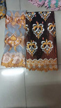 Load image into Gallery viewer, Original Swiss cotton laces with intricate embroidery in chocolate and black colors, featuring golden and white floral designs and scalloped edges
